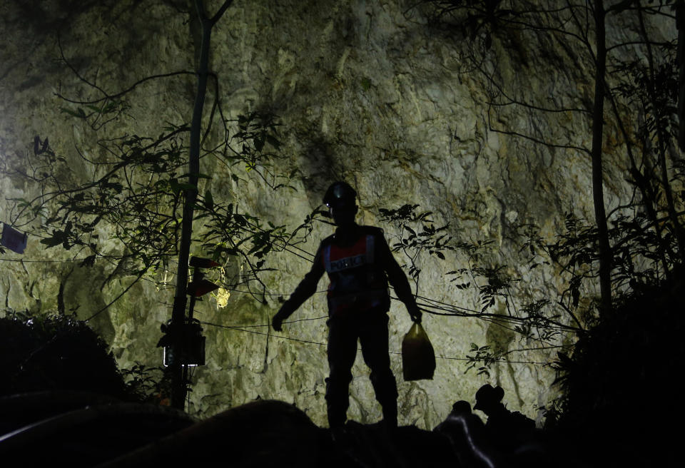 <p>A rescuer makes his way down to the entrance to a cave complex where it’s believed that 12 soccer team members and their coach went missing, in Mae Sai, Chiang Rai province, in northern Thailand, July 1, 2018. (Photo: Sakchai Lalit/AP) </p>