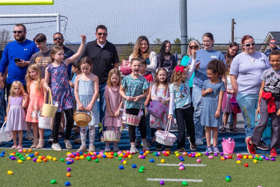 The bigger kids seem eggcited to swarm the football field looking for the treasured prize eggs.