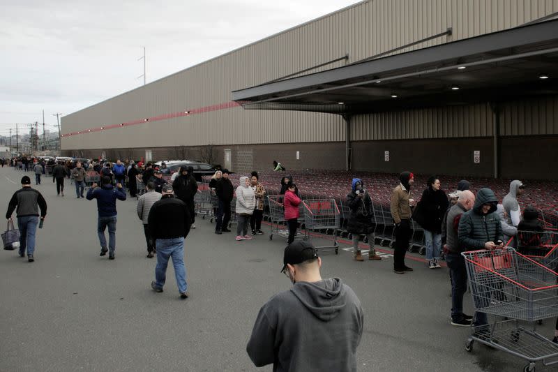 Shoppers line up before opening at a Costco store, following reports of coronavirus disease (COVID-19) cases in the country, in Seattle