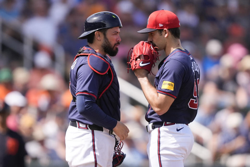 Atlanta Braves starting pitcher Spencer Strider talks with catcher Travis d'Arnaud, left, in the fourth inning of a spring training baseball game against the Detroit Tigers in North Port, Fla., Tuesday, March 5, 2024. (AP Photo/Gerald Herbert)