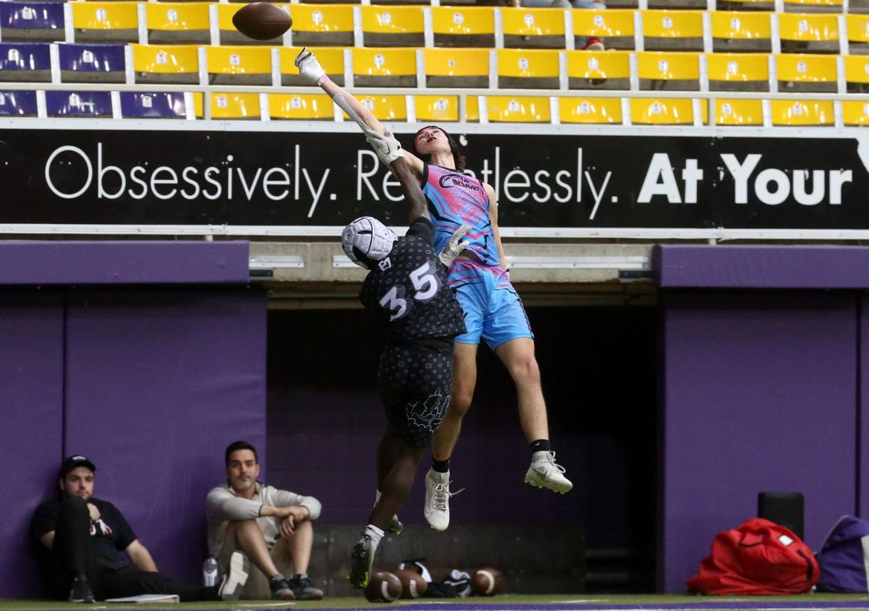 Chase Bradley (4), right, reaches for the ball during a 7-on-7 football tournament Saturday at the UNI Dome in Cedar Falls.