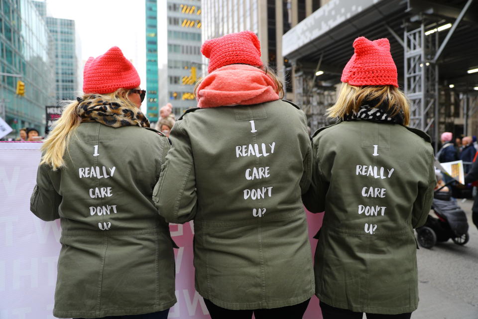 Three sisters march up Sixth Avenue wearing a jacket made famous by U.S. First Lady Melania Trump as they participate in the Womenâs March in New York City on Jan. 19, 2019 in New York City. (Photo: Gordon Donovan/Yahoo News)