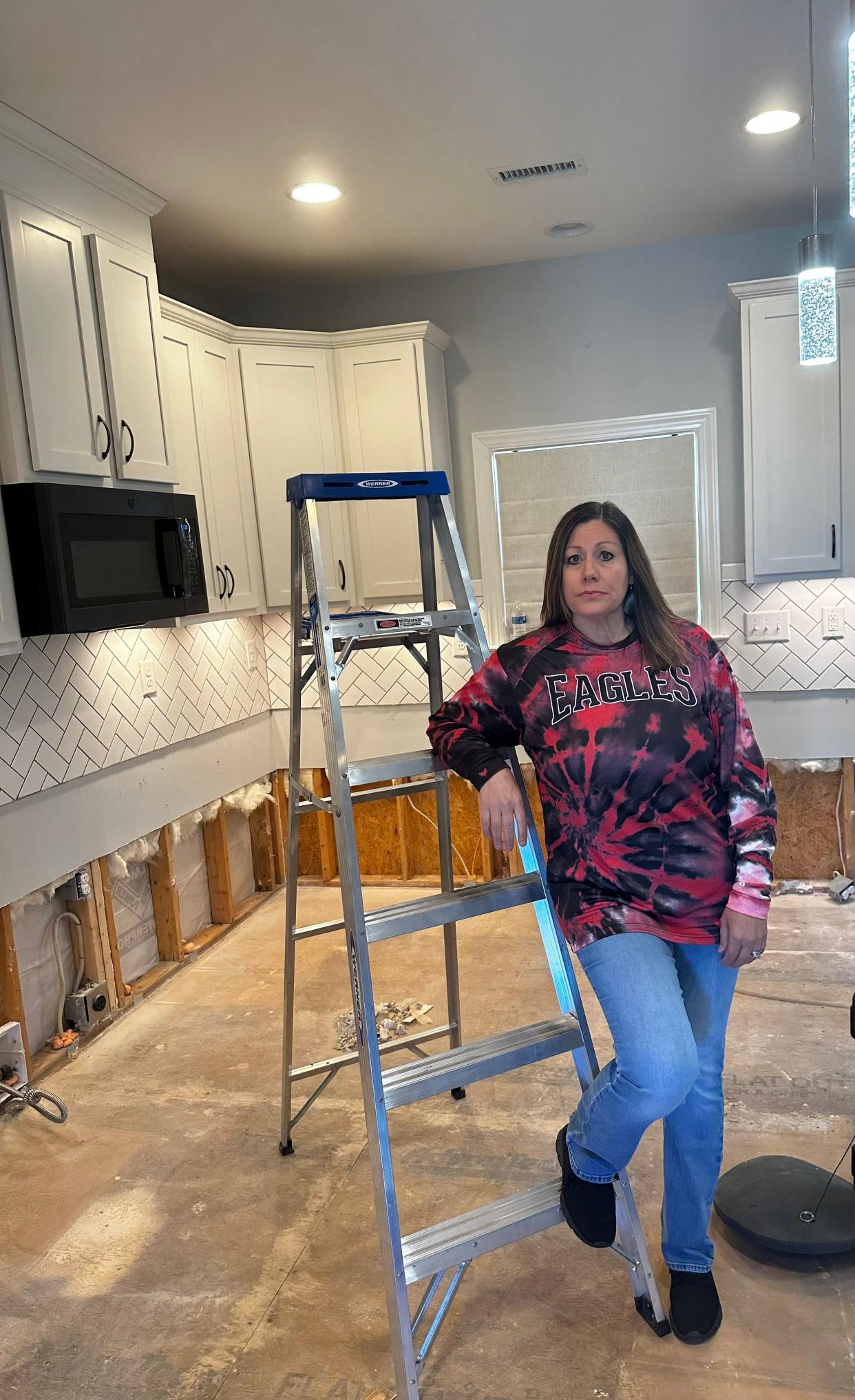 Michelle Taylor stands in the kitchen of her home at Pinnacle Crossing. The house had to be gutted after sewage flooded the floors.