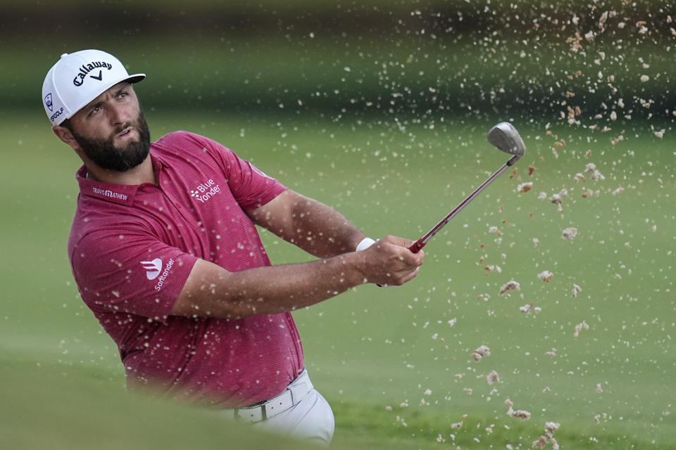 Jon Rahm hits from a bunker on the eighth hole during the third round of the Tour Championship golf tournament, Sunday, Aug. 27, 2023, in Atlanta. (AP Photo/John Bazemore)