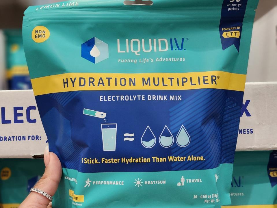 The writer holds a package of Liquid IV drink mix