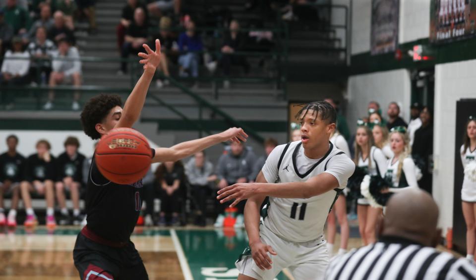 Trinity's Jayden Johnson thinks he's still inbounds as he passes the ball against Ballard's Cash Whitehead in KHSAA Seventh Region boys basketball at Steinhauser Gymnasium on Tuesday night.  March 5, 2024