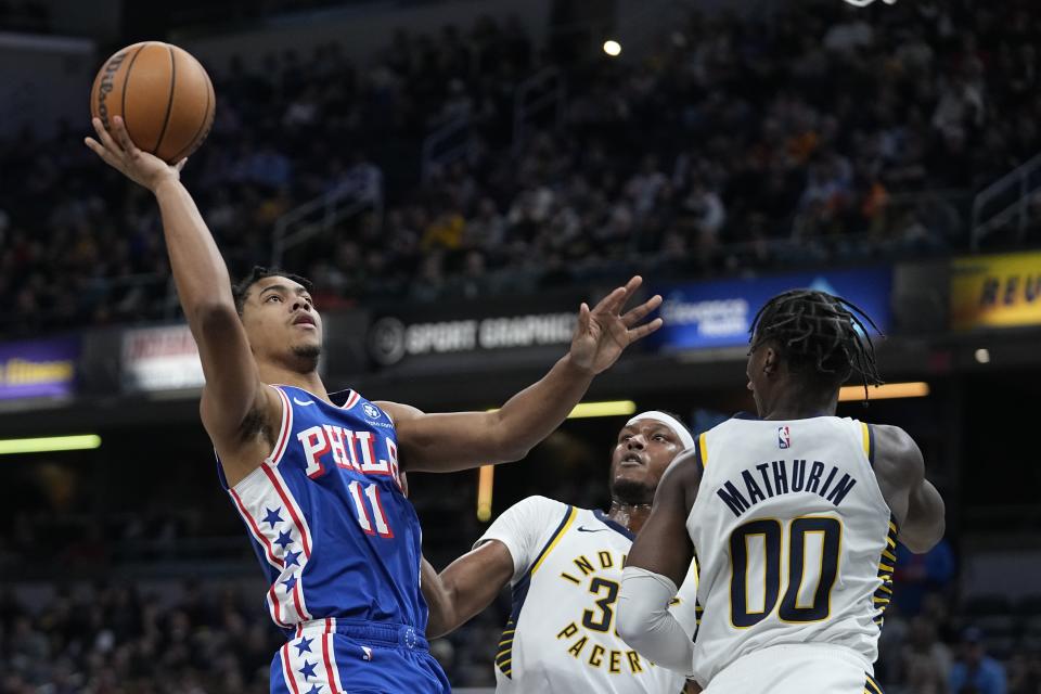 Philadelphia 76ers' Jaden Springer (11) shoots against Indiana Pacers' Myles Turner (33) and Bennedict Mathurin (00) during the first half of an NBA basketball game Thursday, Jan. 25, 2024, in Indianapolis. (AP Photo/Darron Cummings)