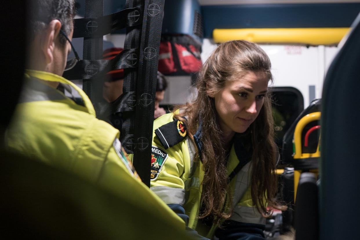 A Thunder Bay paramedic responds to a patient in the back of an ambulance in 2020. A new study is found that paramedics across the province faced a huge surge in demand from patients experiencing opioid-related health impacts.   (Sinisa Jolic/CBC - image credit)