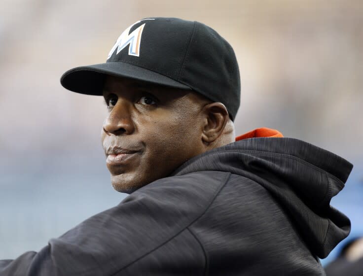 FILE - In this April 27, 2016, file photo, Miami Marlins hitting coach Barry Bonds stands in the dugout.