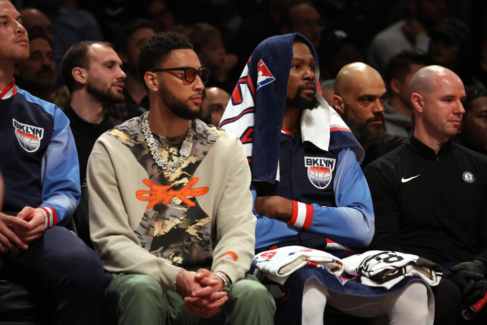 Ben Simmons and Kevin Durant of the Brooklyn Nets watch during the game against the Milwaukee Bucks at the Barclays Center on March 31, 2022 in New York City.