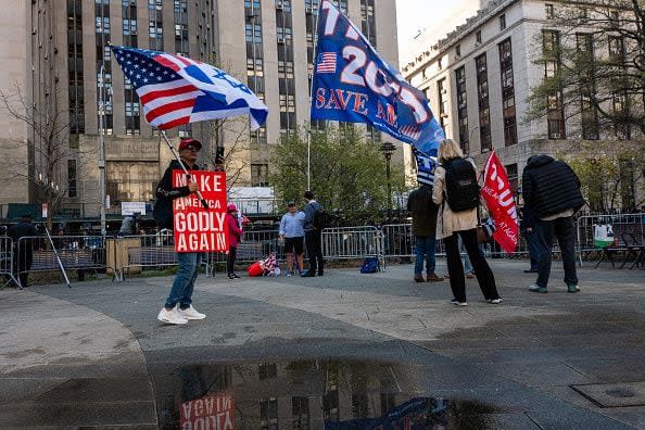 NEW YORK, NEW YORK - APRIL 15: Trump supporters, police and media gather outside of a the Manhattan Criminal Courthouse for the start of first-ever criminal trial against a former president of the United States on April 15, 2024 in New York City. Former President Donald Trump faces 34 felony counts of falsifying business records in the first of his criminal cases to go to trial. (Photo by Spencer Platt/Getty Images)