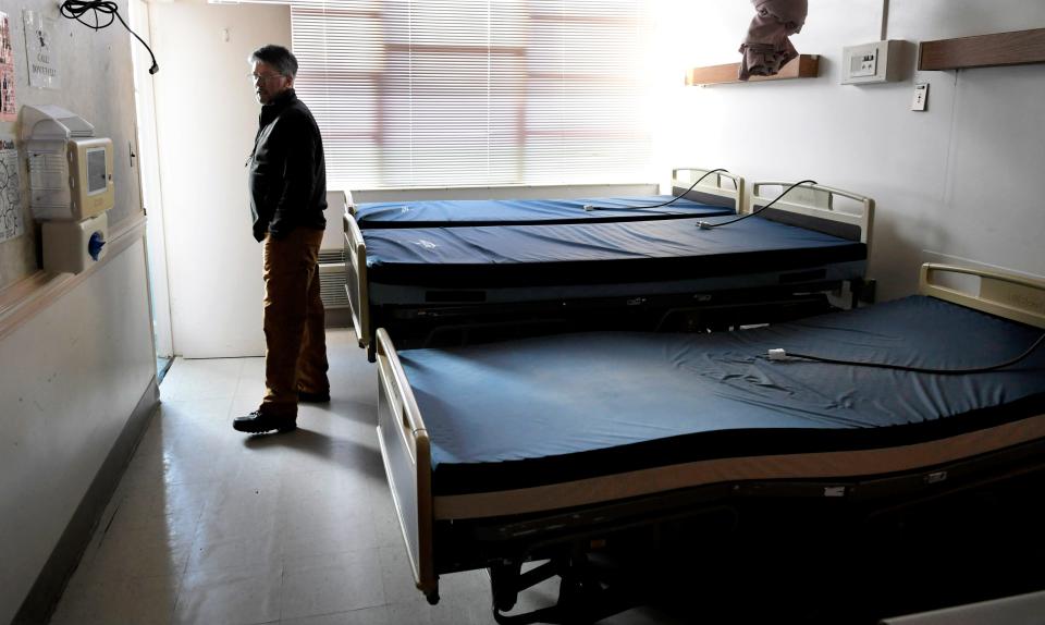 Mayor of Ducktown Mayor Doug Collins stands in the doorway of a room wehre hosptial beds have been stored inside town's shuttered hospital in Ducktown, Tennessee on Dec. 5, 2018. Copper Basin Medical Center closed 15 months ago due to mounting debt.