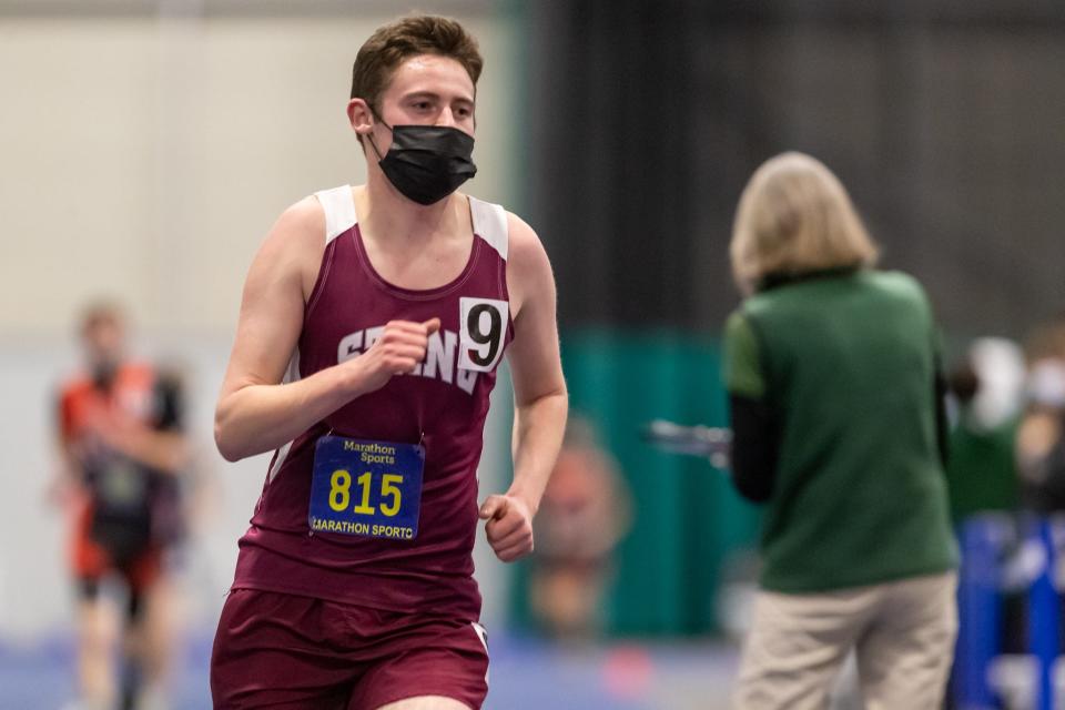 Bishop Stang’s John Campbell races in the 2-mile on Thursday at Wheaton College.