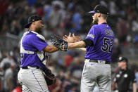 Colorado Rockies pitcher Daniel Bard, right, celebrates with catcher Elias Diaz after the team's win over the Minnesota Twins in a baseball game Friday, June 24, 2022, in Minneapolis. (AP Photo/Craig Lassig)