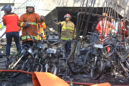 Firefighters are seen at the site of a blast at the Pentecost Church Central Surabaya (GPPS), in Surabaya, East Java, Indonesia May 13, 2018 in this photo taken by Antara Foto. Antara Foto/Moch Asim / via REUTERS