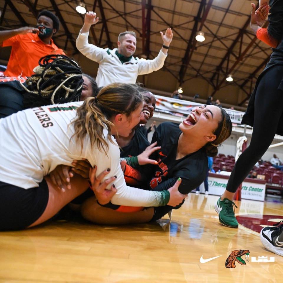 FAMU volleyball players pile on each other in celebration of winning the 2021 SWAC championship on Sunday, Nov. 21. They are the first Rattlers team to win a SWAC title. FAMU joined the conference in July 2021.