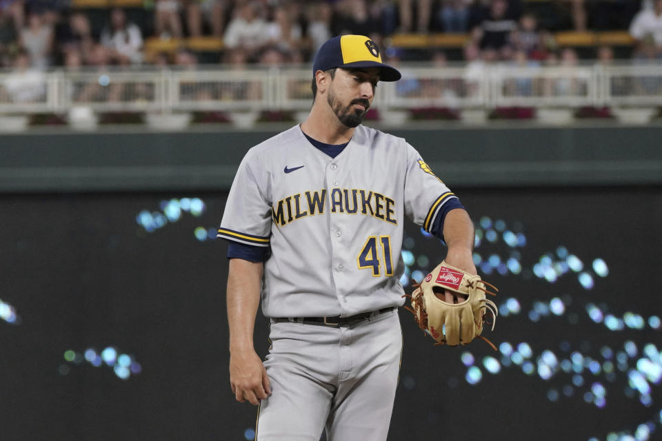 Milwaukee Brewers pitcher Jason Alexander waits for a new ball after Minnesota Twins' Nick Gordon hit an RBI single during the fourth inning of a baseball game Tuesday, July 12, 2022, in Minneapolis. (AP Photo/Jim Mone)