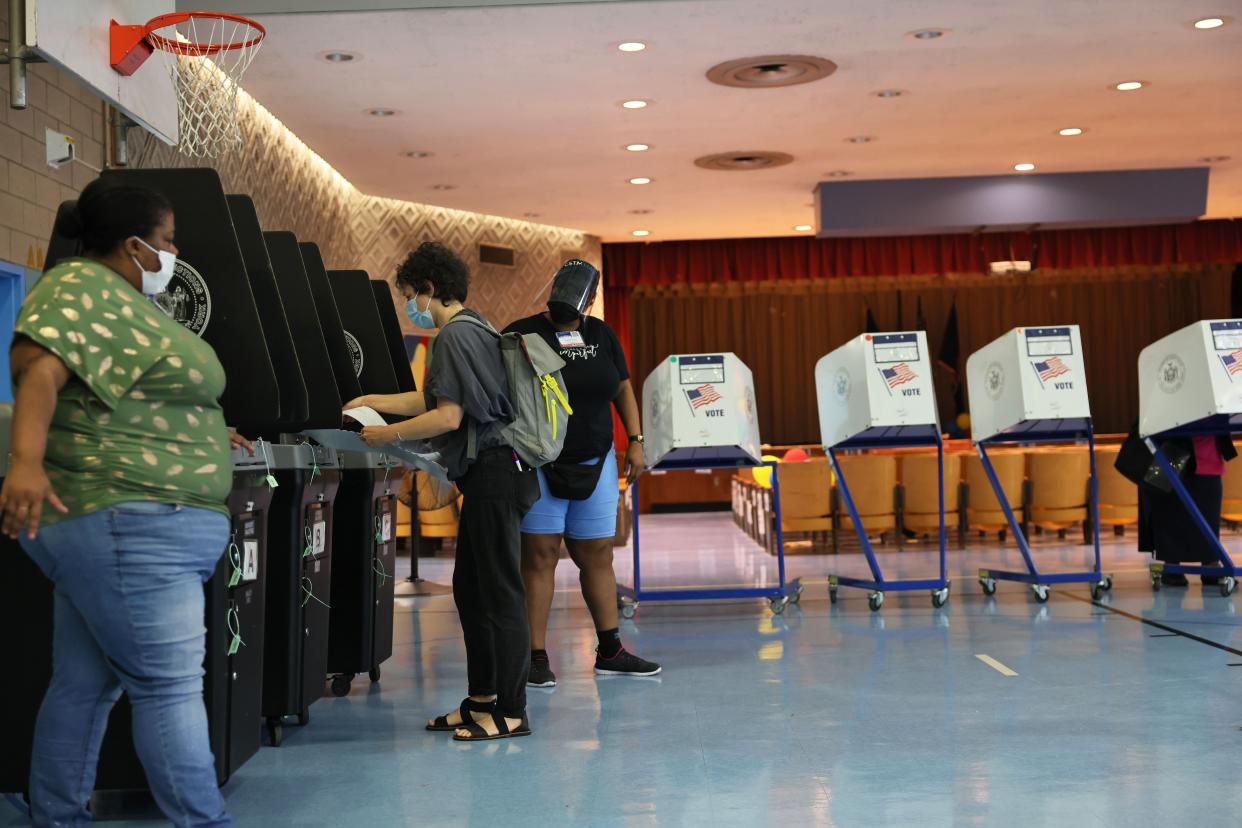 A voter files her voting ballot during the Primary Election Day at P.S. 81 on June 22, 2021, in the Bedford-Stuyvesant neighborhood of Brooklyn.
