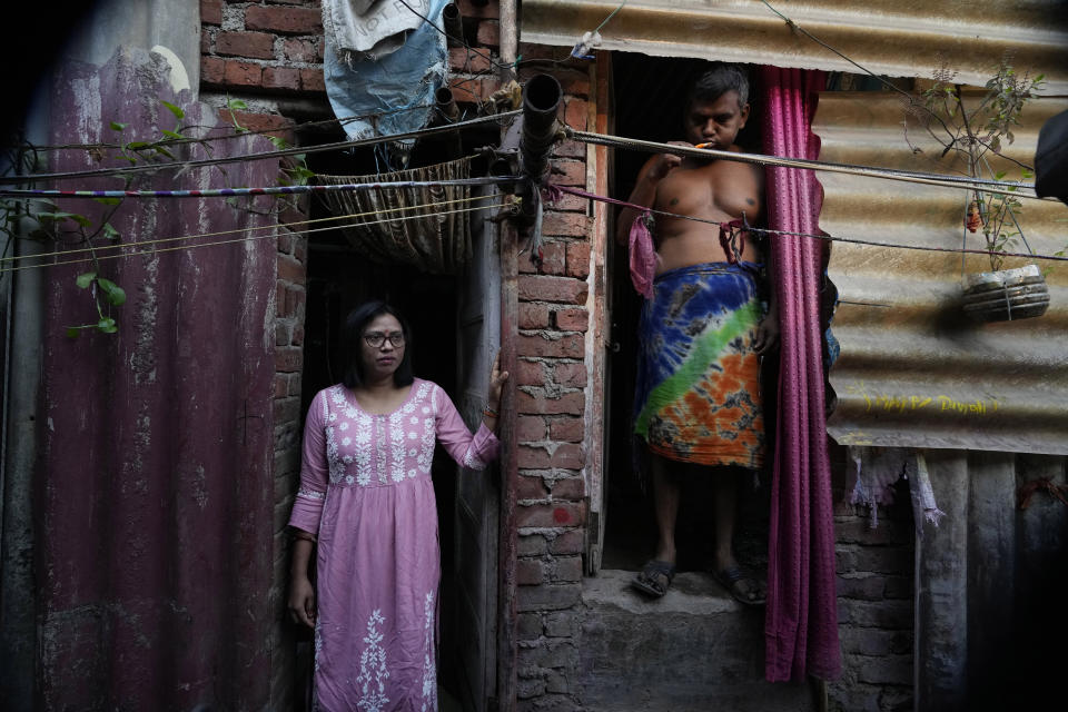 Lalmani Chauhan stands at her residence in a slum in Mumbai, India, Friday, March 17, 2023. It was the promise of jobs and a better life that drew Chauhan to Mumbai. She is the first woman in her family to work - and the first to enroll into university, which she did recently. Her salary is putting her three children - one boy and two girls - through school. (AP Photo/Rajanish Kakade)