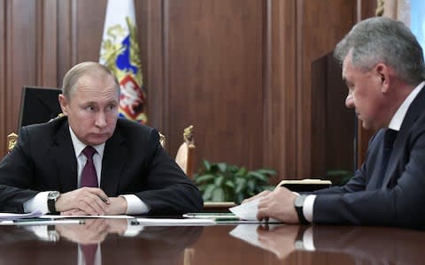 Vladimir Putin announces Russia will also suspend participation in the INF treaty during a meeting with Mr Shoigu and foreign minister Sergei Lavrov on Saturday - Credit: Alexey Nikolsky/AFP/Getty