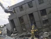 Rescue personnel work at a damaged building after an earthquake in Tainan, southern Taiwan, February 6, 2016. REUTERS/Pichi Chuang