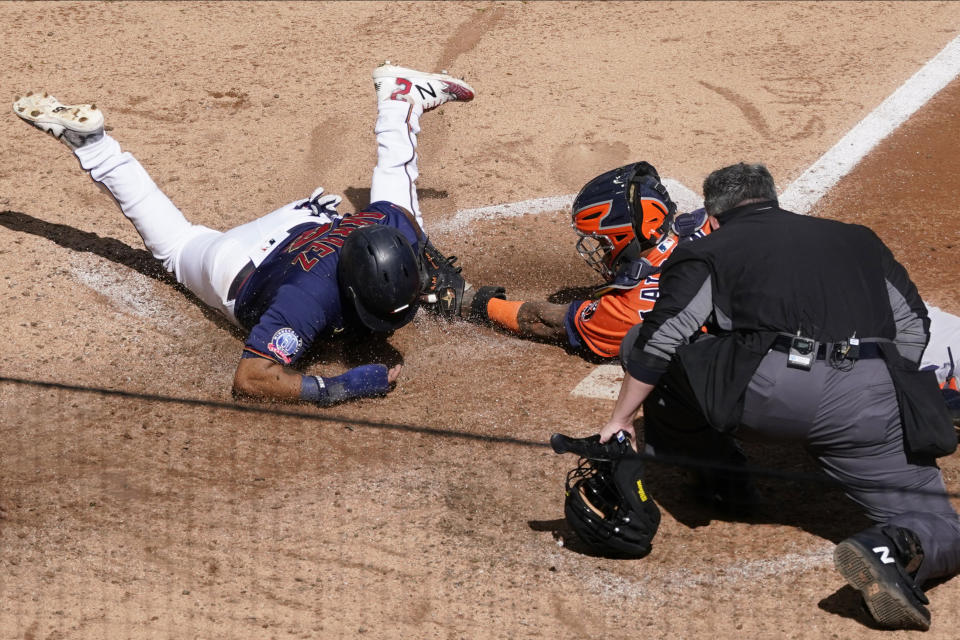 Minnesota Twins' Luis Arraez, left, is tagged out by Houston Astros catcher Martin Maldonado as he attempted to score on a Marwin Gonzalez single in the fifth inning of Game 2 of an American League wild-card baseball series, Wednesday, Sept. 30, 2020, in Minneapolis. Home plate umpire Manny Gonzalez watches to make the call. (AP Photo/Jim Mone)