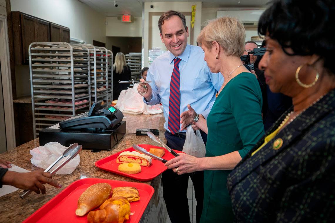Rep. Wiley Nickel, Rep. Deborah Ross, and Rep.Valerie Foushee pay for their baked goods during a visit to the Panaderia Artisanal bakery on Monday, January 30, 2023 in Raleigh, N.C.