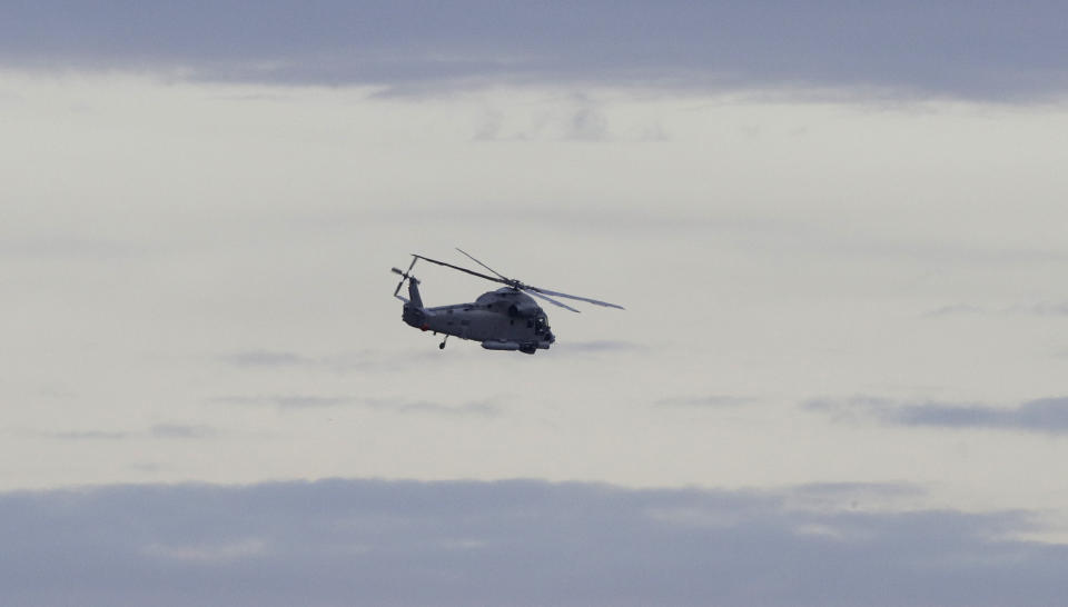 A New Zealand Navy helicopter takes off from Whakatane Airport as the mission to return victims of the White Island eruption begins in Whakatane, New Zealand, Friday, Dec. 13, 2019. A team of eight New Zealand military specialists landed on White Island early Friday to retrieve the bodies of victims after the Dec. 9 eruption. (AP Photo/Mark Baker)