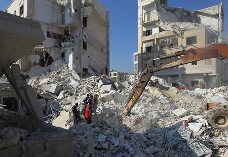 People search for survivors under the rubble of a site hit by airstrikes in the rebel-held city of Idlib, Syria February 7, 2017. REUTERS/Ammar Abdullah