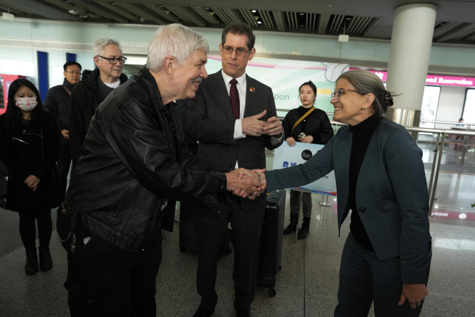 Philadelphia Orchestra's 73-year-old violinist Davyd Booth, left is greeted by Shari Bistransky, Counselor for Public Affairs of the United States Embassy to China, at the Beijing Capital International Airport on Tuesday, Nov. 7, 2023. Musicians from the Philadelphia Orchestra arrived in Beijing on Tuesday, launching a tour commemorating its historic performance in China half a century ago in signs of improving bilateral ties ahead of a highly anticipated meeting between President Joe Biden and Xi Jinping. (AP Photo/Ng Han Guan)