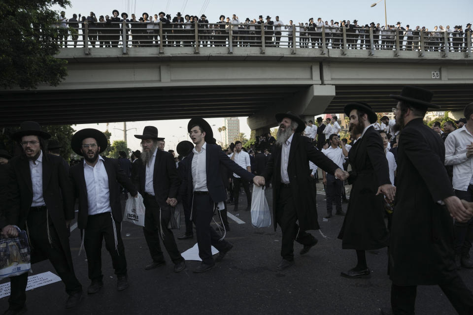 Ultra-Orthodox Jewish men block a highway during a protest against army recruitment in Bnei Brak, Israel, Thursday, June 27, 2024. Israel's Supreme Court unanimously ordered the government to begin drafting ultra-Orthodox Jewish men into the army — a landmark ruling seeking to end a system that has allowed them to avoid enlistment into compulsory military service. (AP Photo/Oded Balilty)