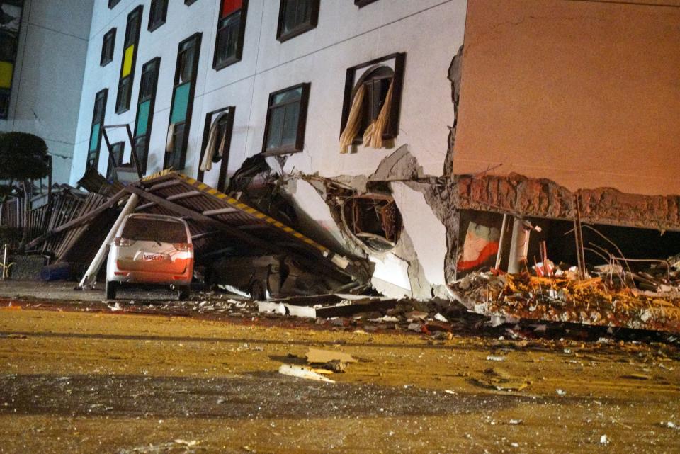 <p>A damaged vehicle stands in rubble outside the Marshal Hotel in Hualien, eastern Taiwan early February 7, 2018, after a strong earthquake struck the island. (Photo: Paul Yang/AFP/Getty Images) </p>