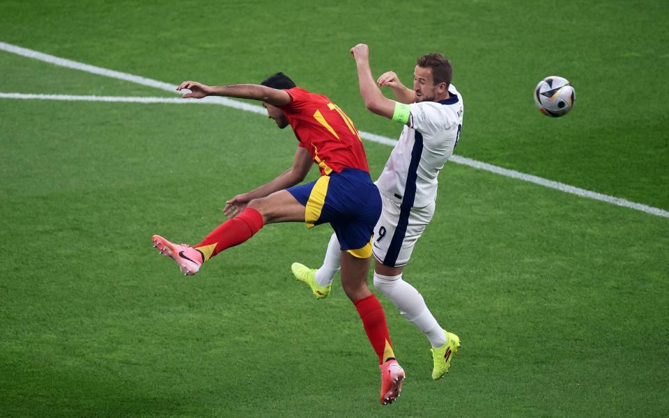 Rodri of Spain competes for a header with Harry Kane