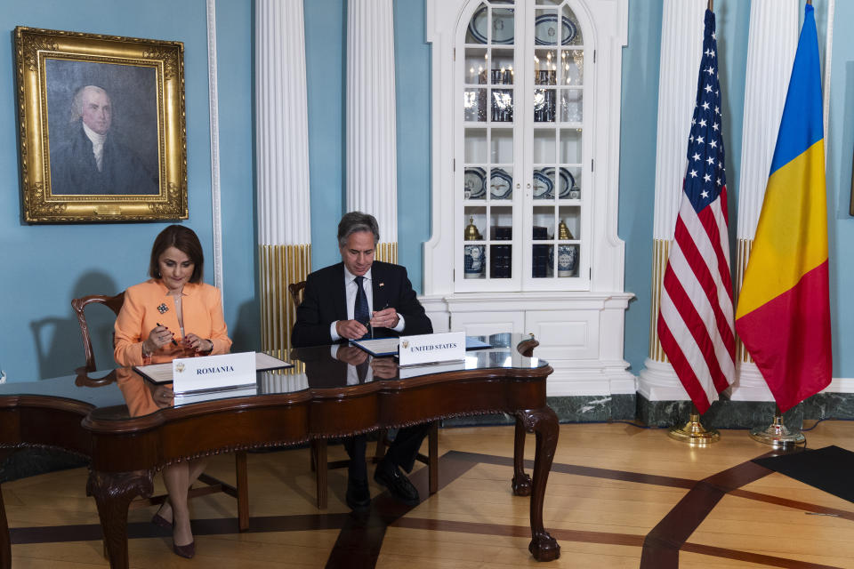 Secretary of State Antony Blinken and Romanian Foreign Minister Luminița-Teodora Odobescu, left, sign a memorandum of understanding during a ceremony at the State Department, Friday, June 21, 2024, in Washington. (AP Photo/Manuel Balce Ceneta)