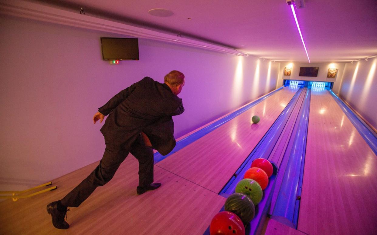 Mr Wildin using the bowling alley in his private leisure centre - SWNS +44 (0)1179066550