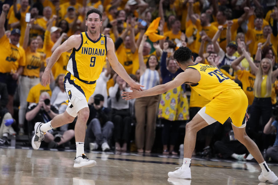 Indiana Pacers guard T.J. McConnell (9) celebrates with teammate Ben Sheppard (26) after making a basket during the second half against the Milwaukee Bucks in Game 6 in an NBA basketball first-round playoff series, Thursday, May 2, 2024, in Indianapolis. (AP Photo/Michael Conroy)