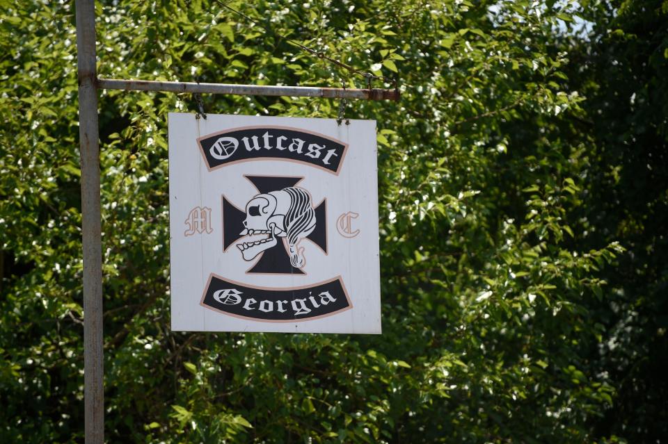 FILE - The Outcast Georgia sign hangs outside the motorcycle club headquarters on East Boundary and Sand Bar Ferry Road in Augusta, Ga., on Monday, May 15, 2023.