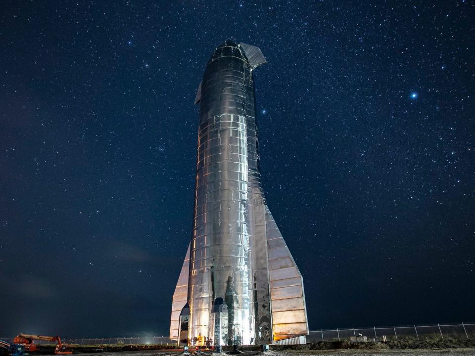 An early prototype of Starship is shown against the night sky