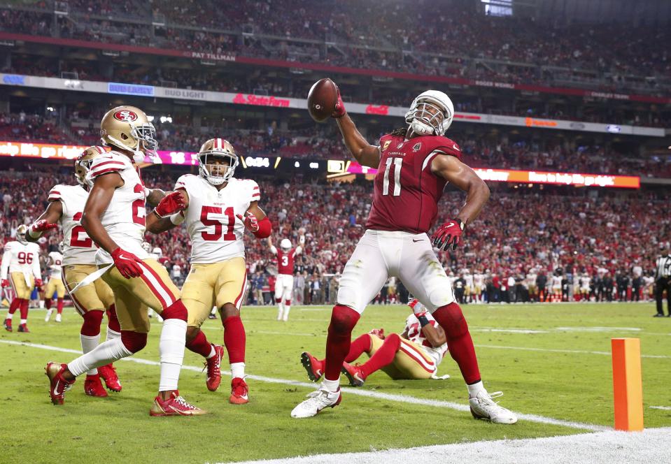 Arizona Cardinals wide receiver Larry Fitzgerald (11) spikes the football after a two-point conversion against the San Francisco 49ers In the fourth quarter during NFL action against the San Francisco 49ers on Oct. 28 at State Farm Stadium.