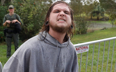 A demonstrator yells during a rally outside the location where Richard Spencer was delivering a speech in Gainesville - Credit: Reuters