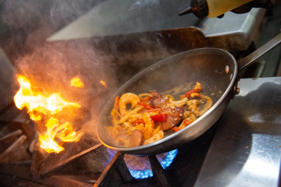 Loveys Seafood & Grill Chef Charles Smith sautés shrimp and andouille sausage with spices and red bell pepper as he makes Hilly City pasta, at the Vicksburg, Miss., restaurant Thursday, Oct. 19, 2023.