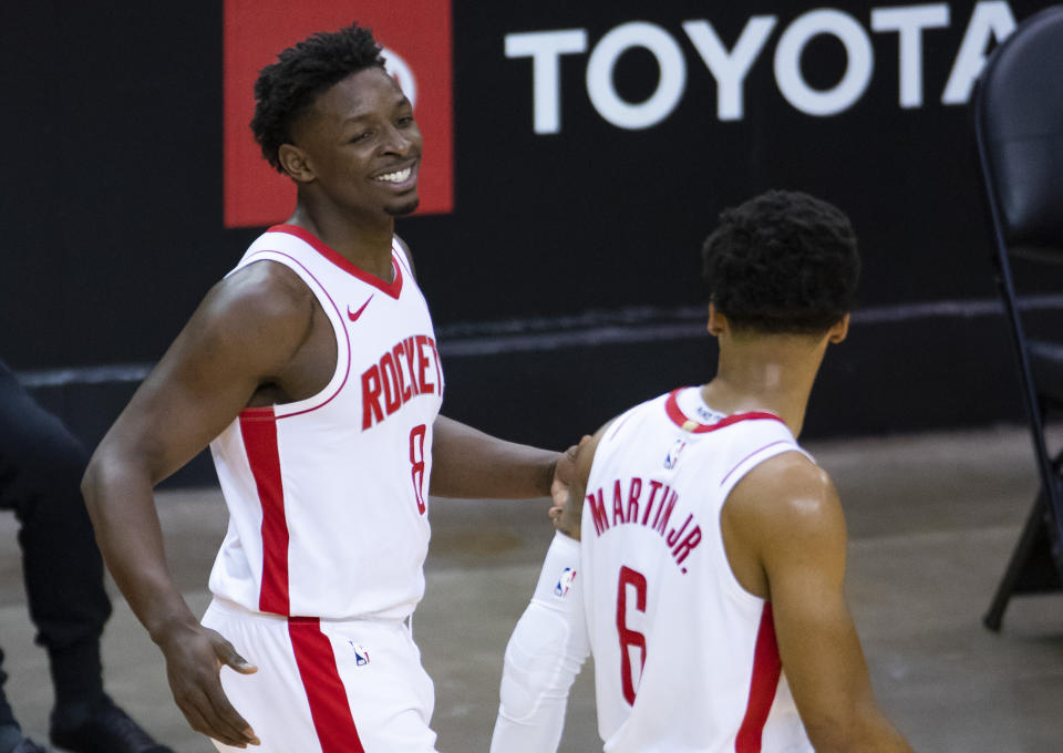 Houston Rockets forward Jae'Sean Tate (8) celebrates with forward Kenyon Martin Jr. (6) after a play during the third quarter of an NBA game against the Los Angeles Clippers on Friday, May 14, 2021, in Houston. (Mark Mulligan/Houston Chronicle via AP)