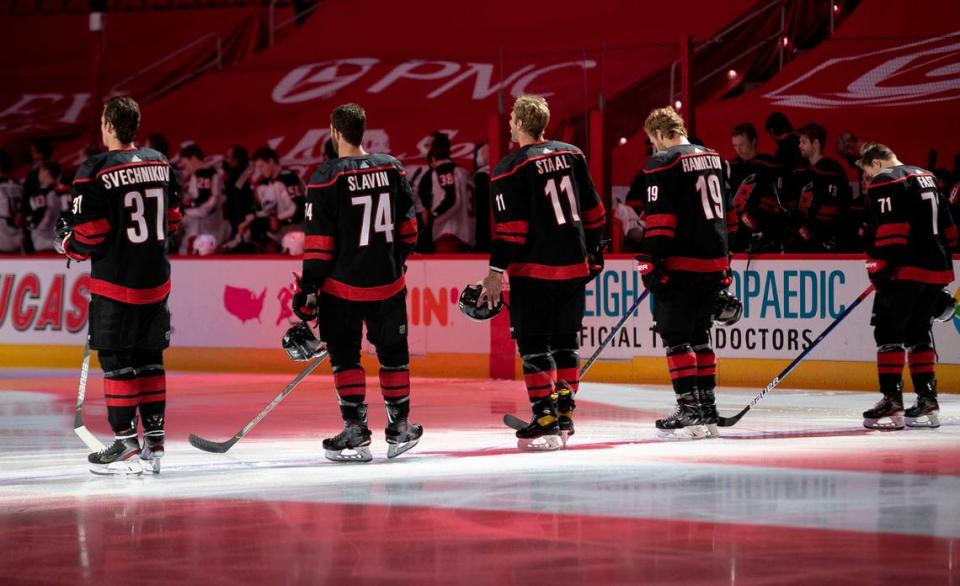 Carolina Hurricanes’ Andrei Svechnikov (37), Jaccob Slavin (74), Jordan Staal (11), Dougie Hamilton (19) and Jesper Fast (71) line up for the National Anthem prior to their game against Columbus on Thursday, March 18, 2021 at PNC Arena in Raleigh, N.C.