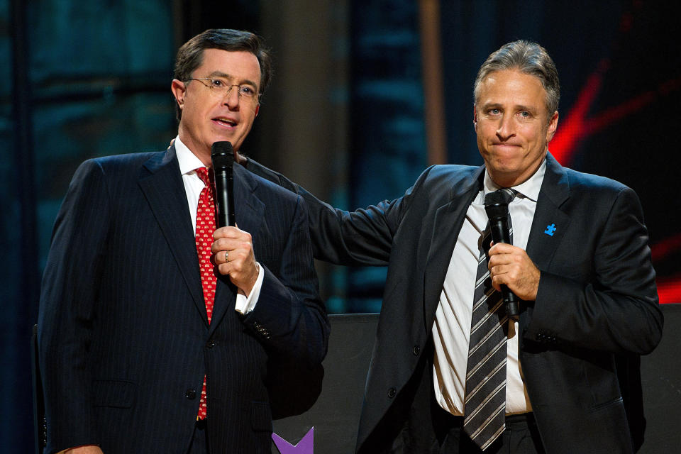 FILE - In this Oct. 2, 2010 file photo, Stephen Colbert, left, and Jon Stewart appear on stage at Comedy Central's "Night Of Too Many Stars: An Overbooked Concert For Autism Education" at the Beacon Theatre in New York. Comedy Central announced Wednesday, July 25, 2012, that Jon Stewart has extended his contract to host The Daily Show through mid-2015. Stephen Colbert also signed an extension that takes him through the end of 2004 as host of The Colbert Report. (AP Photo/Charles Sykes)