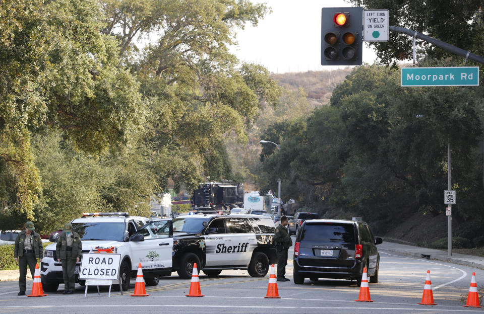 Police block the entrance to the parking lot leading to the Borderline Bar & Grill in Thousand Oaks, Calif., Thursday, Nov. 8, 2018. A gunman opened fire Wednesday evening inside a country music bar, killing multiple people. Terrified patrons hurled barstools through windows to escape or threw their bodies protectively on top of friends as a Marine combat veteran killed multiple people at a country music bar in an attack that added Thousand Oaks to the tragic roster of American cities traumatized by mass shootings.(AP Photo/Damian Dovarganes)