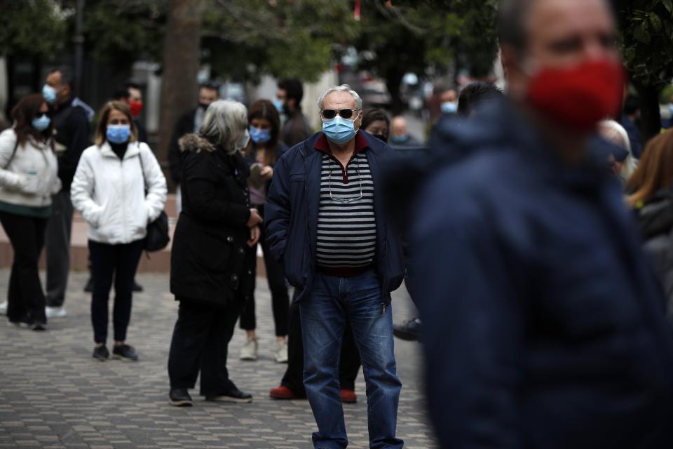 People stand in a queue to conduct rapid tests for the COVID-19 in Athens, Wednesday, March 3, 2021. Greece has recorded a new spike in COVID-19 infections, nearly half of which were recorded in the greater Athens region where hospital intensive care units are quickly filling up. (AP Photo/Thanassis Stavrakis)