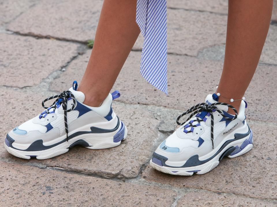 Woman with white, blue and purple Balenciaga sneakers before Salvatore Ferragamo fashion show, Milan Fashion Week street style