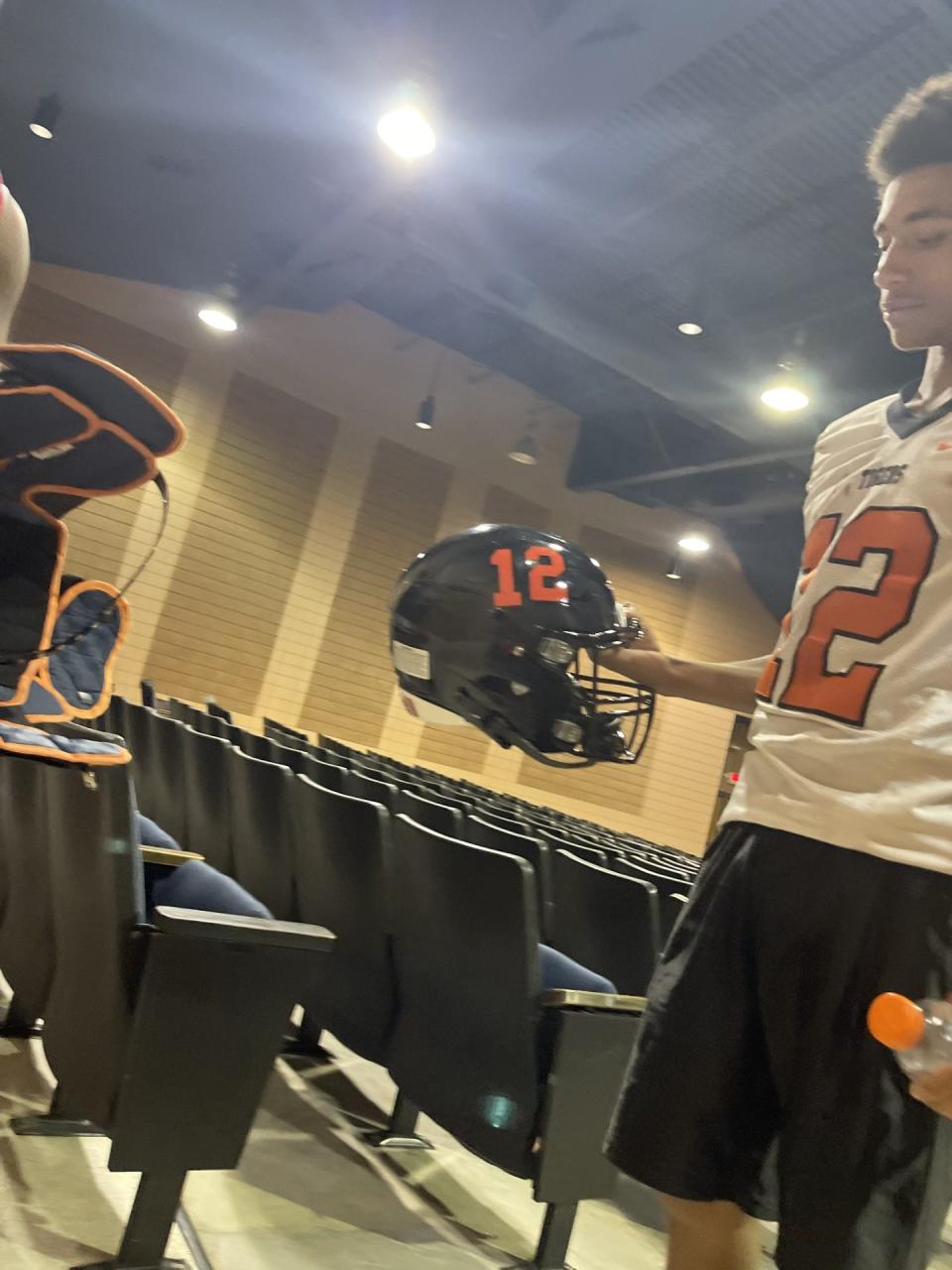 South View football player Chase Evans looks over a brand new helmet received just in time for Week 2's game after an electrical fire at South View High School damaged or destroyed nearly all of the football team's equipment on Aug. 19, 2023.