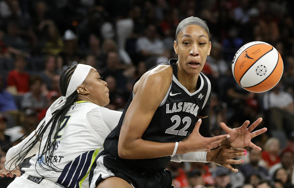 Dallas Wings guard Odyssey Sims (2) knocks the ball away from Las Vegas Aces center A'ja Wilson (22) during the second half of a WNBA basketball game Sunday, July 7, 2024, in Las Vegas. (Steve Marcus/Las Vegas Sun via AP)