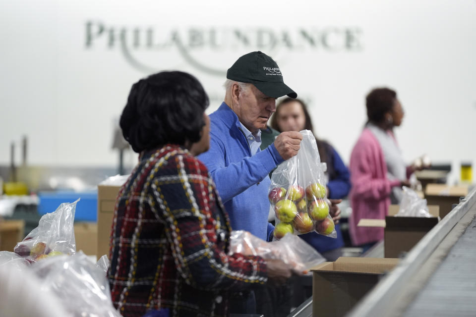 President Joe Biden volunteers at Philabundance, a hunger relief organization, to mark Martin Luther King, Jr., day, Monday, Jan. 15, 2024, in Philadelphia, with Philadelphia Mayor Cherelle Parker, left. (AP Photo/Evan Vucci)